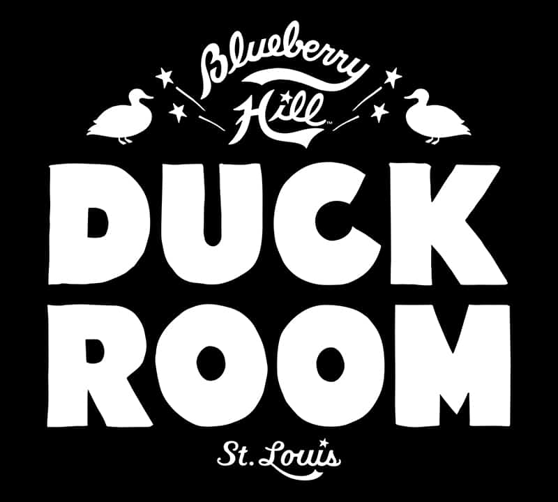 Logo featuring hand-drawn fat letters saying "Duck Room" in white on a black background. A script logo of Blueberry Hill is on top of it and St. Louis in script is below. There are two ducks on either side.