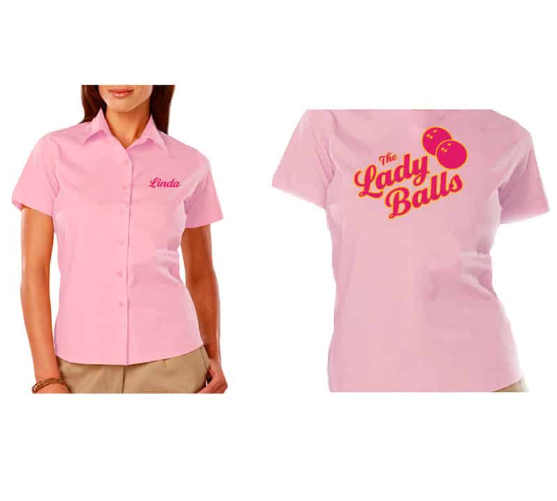 A custom pink bowling shirt with the logo for the Lady Balls women's bowling team. The logo features hot magenta script letters with gold outline. Two bowling balls are to the right.