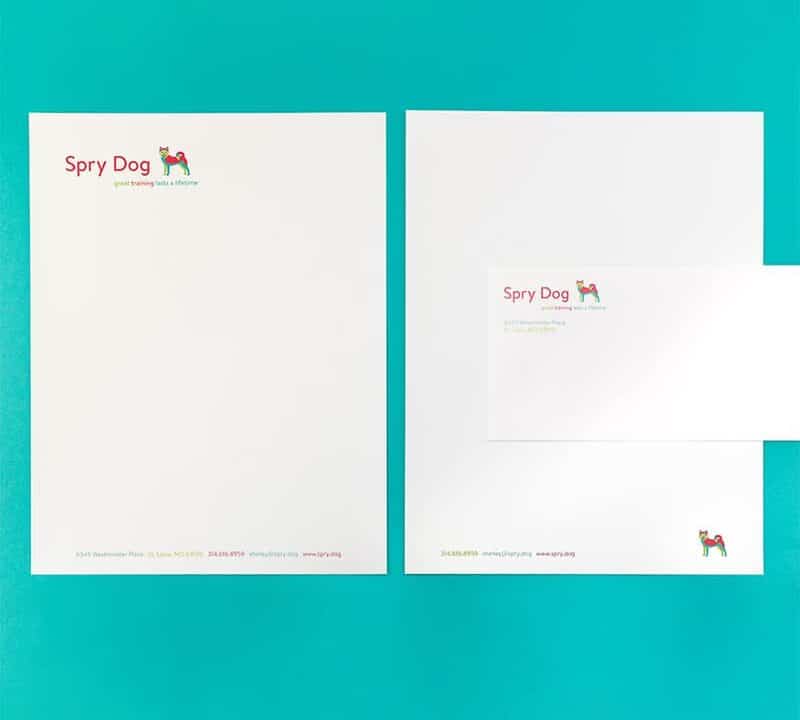 Custom stationery and envelope featuring custom logo for a dog training company featuring a red, turquoise and lime green illustration of an Akita dog.