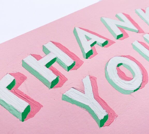Hand-painted 3D block letters that say "Thank You" with green shaded sides and a bubblegum pink background
