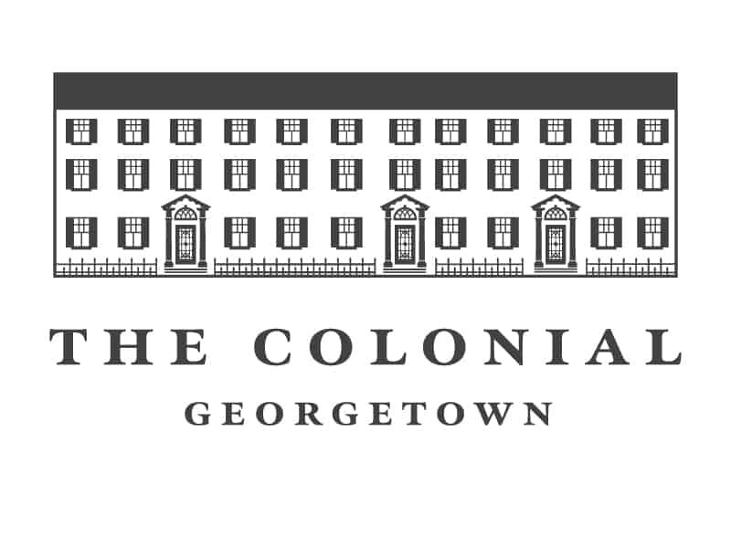 A charcoal gray logo on charcoal on a white background featuring a line drawing of a Colonial-style historic building with three doors and many windows. In elegant serif type it says "The Colonial Georgetown".